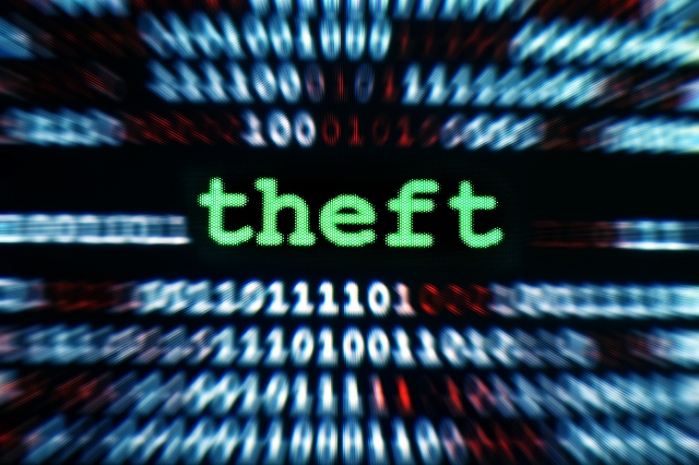 Close up of code on a computer screen with the word Theft in the center in green text